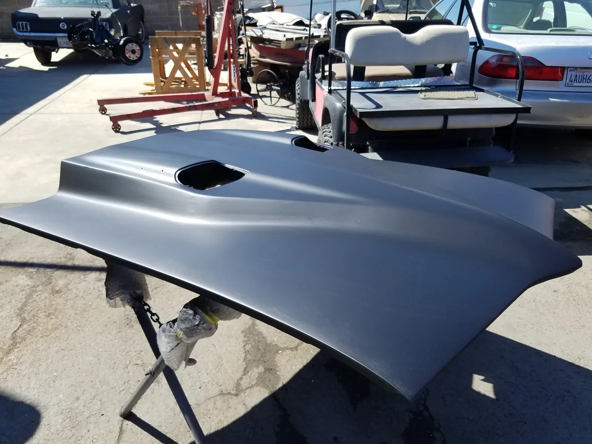 Same hood panel fully repaired with smooth silver finish