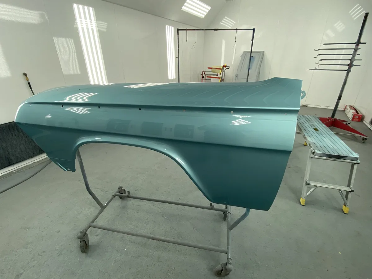 Teal classic car body section with professional finish