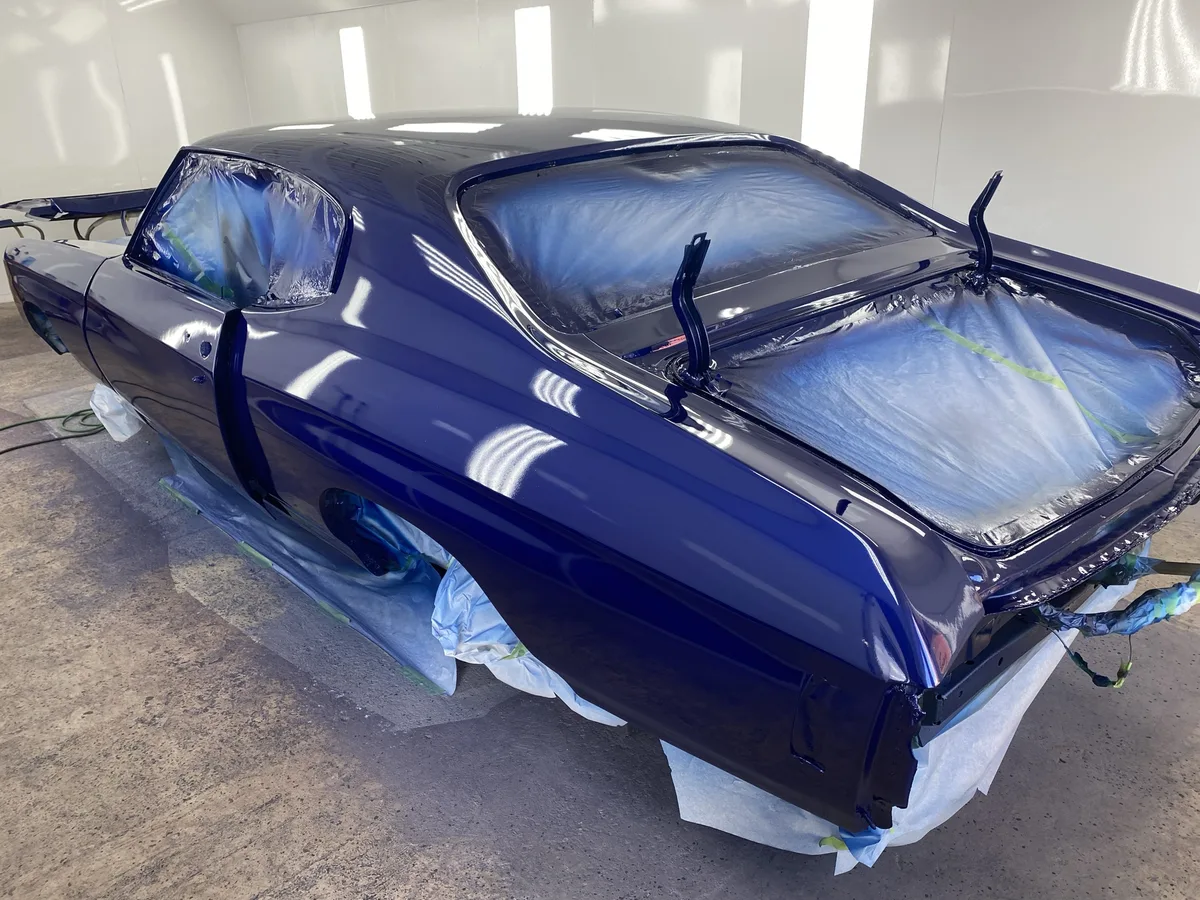 Dark blue classic sedan prepared for paint restoration
