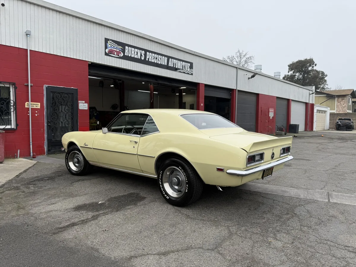 Classic convertible on lift mid-restoration in shop